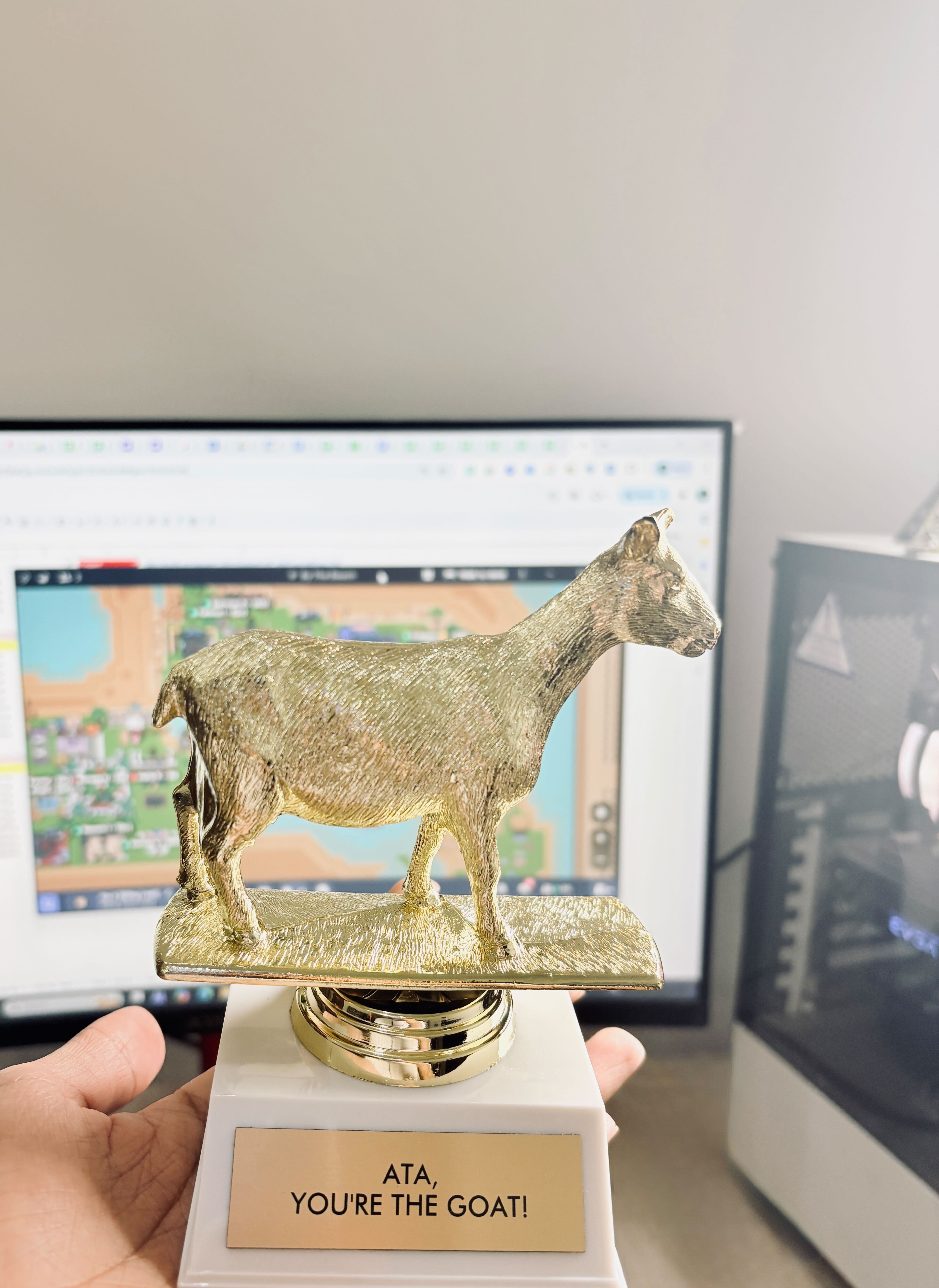 Ata Agha holding a gold GOAT trophy — ATA, YOU'RE THE GOAT